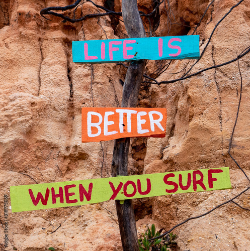 Colorful wooden signpost with the motto 