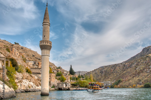 Minaret of the mosque in the water of the dam