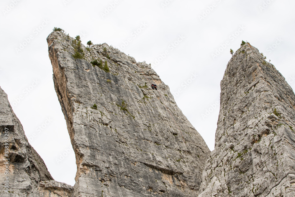 August 28, 2019: climbers on a rock wall of the Cinque Torri, in the Italian Dolomites August 28, 2019: climbers on a rock wall of the Cinque Torri, in the Italian Dolomites