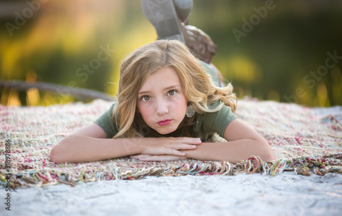 Beautiful Young Girl On Blanket By Lake