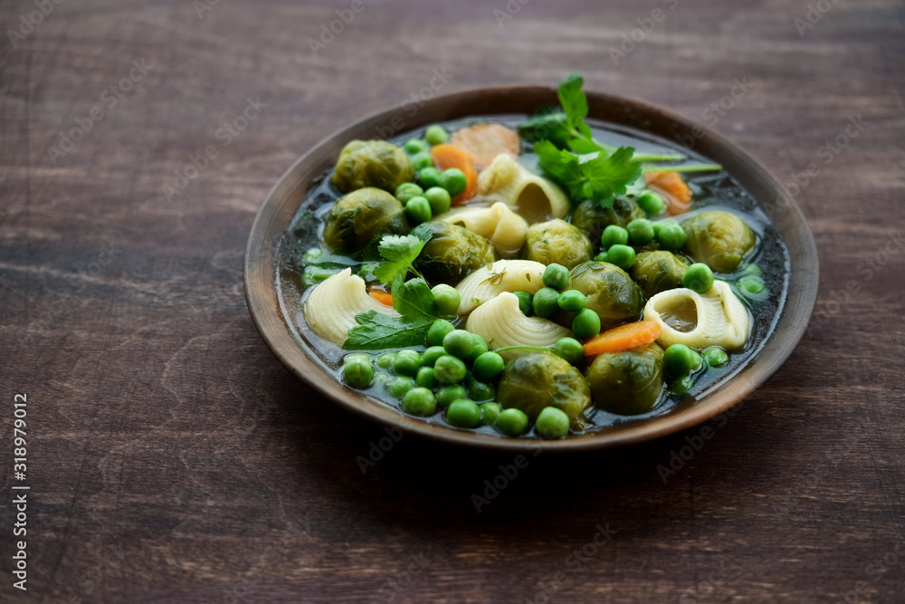 Seasonal Italian minestrone soup with pasta, brussels sprouts, carrots and peas Seasonal Italian minestrone soup with pasta, brussels sprouts, carrots and peas