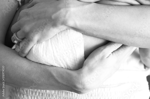 Mothers Arms Wrapped Around Baby 