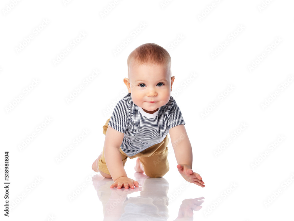 Interested infant child boy in t-shirt and green pants is crawling on all fours, looking at us on white Interested infant child boy in t-shirt and green pants is crawling on all fours, looking at us on white