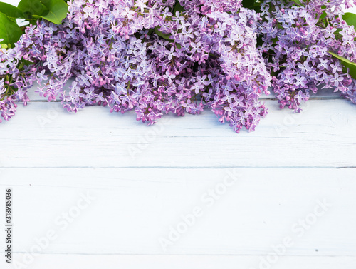 Bouquet of purple lilacs flowers on a light blue shabby wooden background. Vintage floral background with spring flowers. Copy space