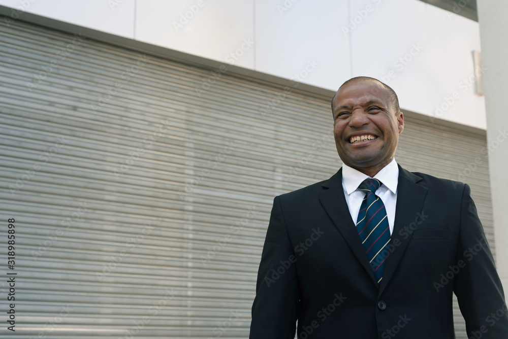 Black businessman in a suit loking successfull in an urban background Black businessman in a suit loking successfull in an urban background