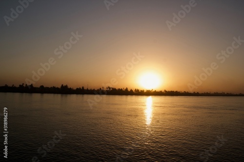 Sunset viewed from across a river © Sridhar
