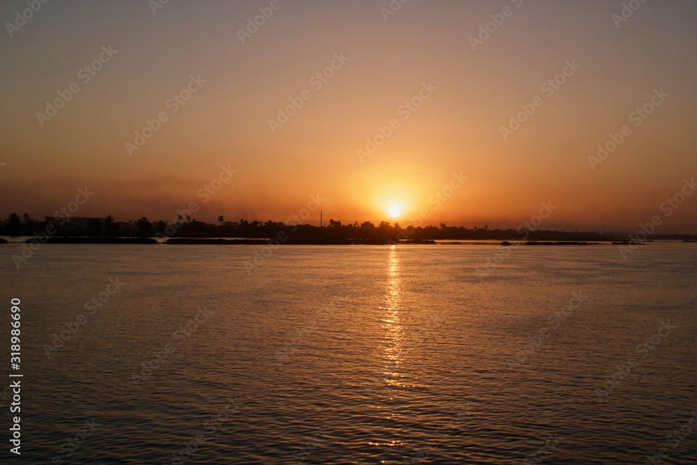 Sunset viewed from across a river