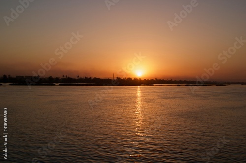 Sunset viewed from across a river © Sridhar