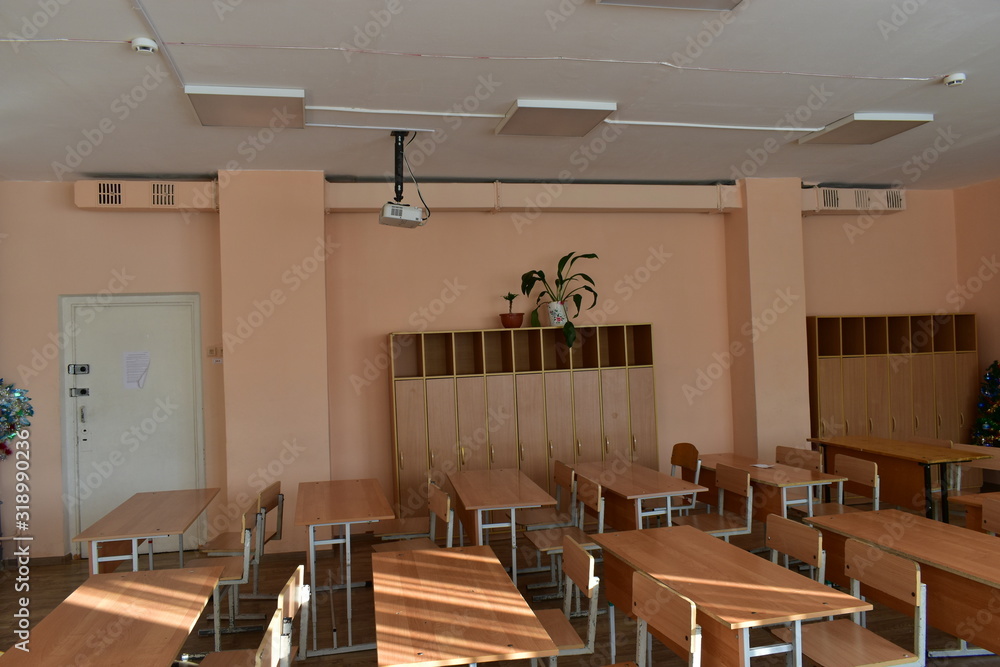 School classroom with desks and a projector