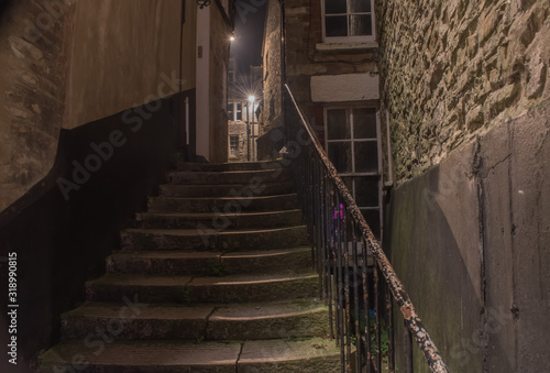 The well worn alleyway dimly lit passage steps