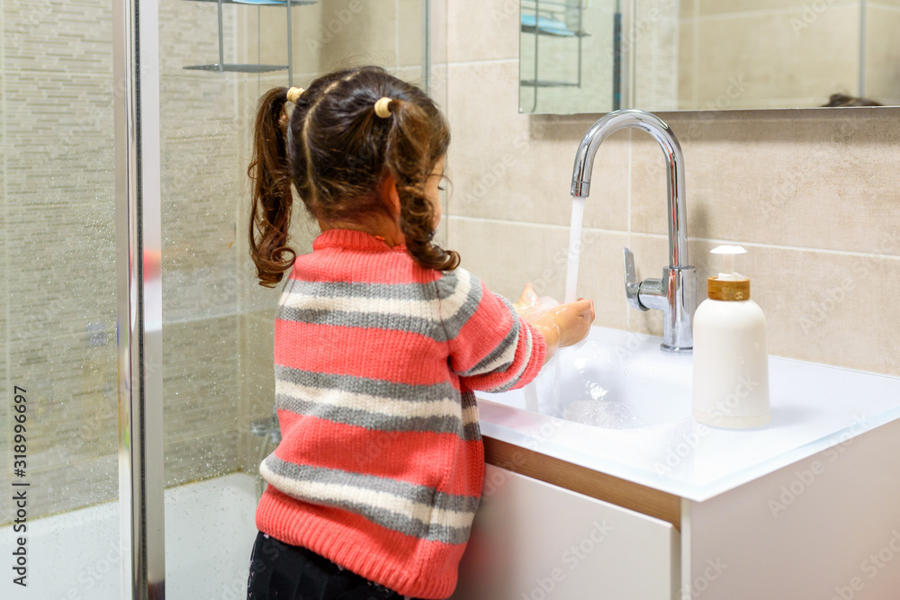 Toddler washing her hands in the sink. Clean hands protect against infection and virus. Toddler washing her hands in the sink. Clean hands protect against infection and virus.