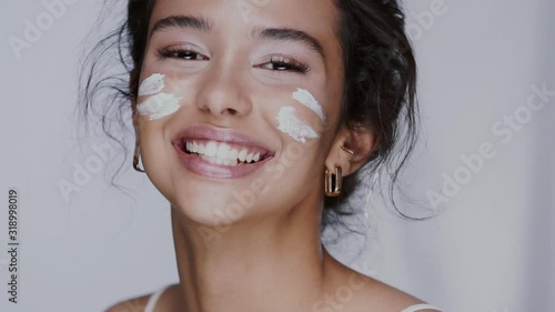 pretty girl putting cream on her chick and nose playing and laughing