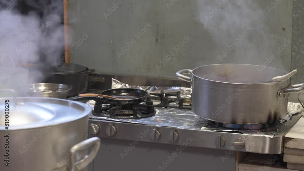 Steel casseroles in the kitchen with food Steel casseroles in the kitchen with food