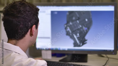 Designer Working on Desktop Computer, Screen Showing CAD Software with 3D Plastic Component for Automotive