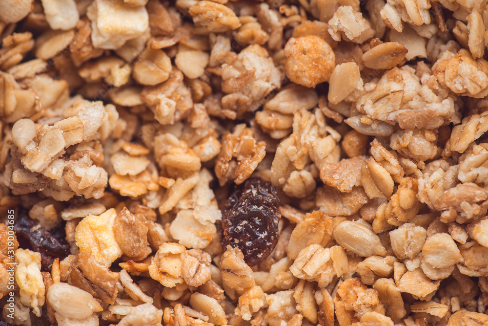 Useful and tasty muesli with nuts, rasins and flakes. Selective focus macro shot with very shallow depth of field. Healthy and vegetarian lifestyle Useful and tasty muesli with nuts, rasins and flakes. Selective focus macro shot with very shallow depth of field. Healthy and vegetarian lifestyle