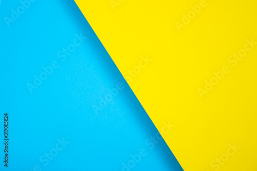 Colored paper background. bright color, blue and yellow. diagonally, with a shadow