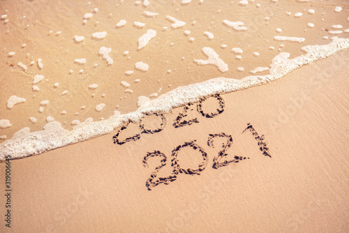 New Year 2021 replace 2020 on the sea beach concept.