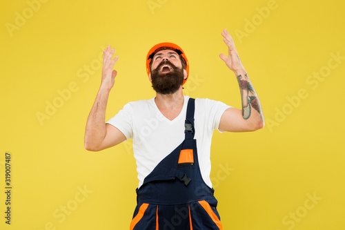 Finally. Engineered environment trend. Builder hard hat. Improvement and renovation. Brutal man builder. Bearded guy worker on yellow background. Engineer builder uniform. Home decor. Feel relief photo