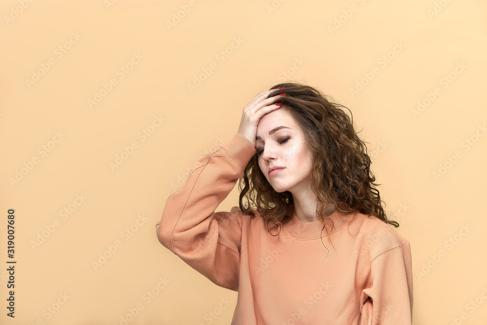 Fototapeta premium Portrait of a young beautiful woman wearing sweatshirt posing isolated over yellow background