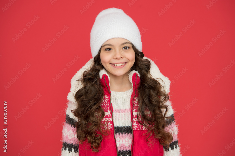 Kids tend to feel cold more than adults. Great features and design. Winter fashion. Small girl long curly hair. Winter holidays ideas. Winter activity for kids. Happy childhood. Child in knitted hat Kids tend to feel cold more than adults. Great features and design. Winter fashion. Small girl long curly hair. Winter holidays ideas. Winter activity for kids. Happy childhood. Child in knitted hat