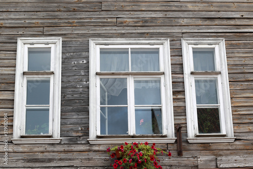 three white wooden window frames and flower box