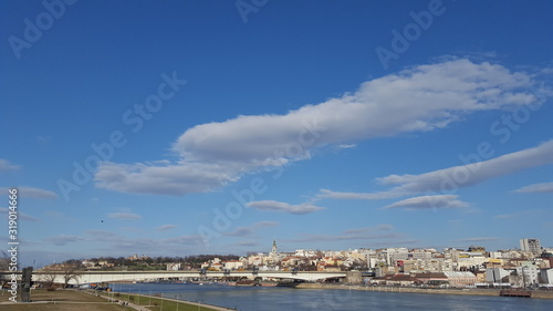 Panorama of the city by the river and the bridge