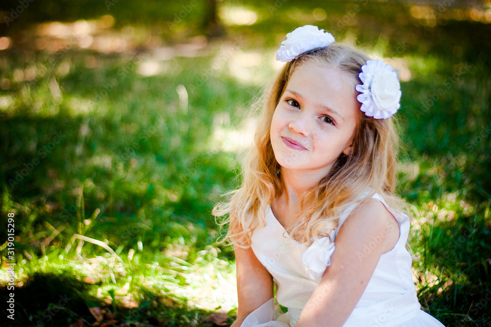 Beautiful Girl Sits In The Park and Looks Into Camera