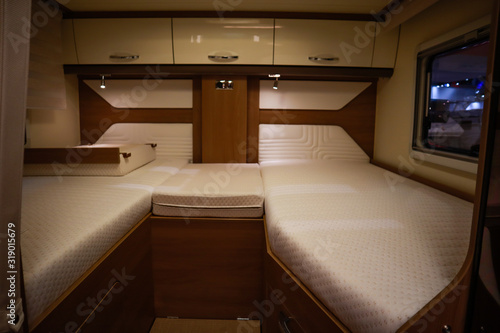 Interior of luxury caravan. Detail photo of coach with equipment.Bedroom and bed
