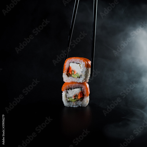 Sushi filadelfia on black background