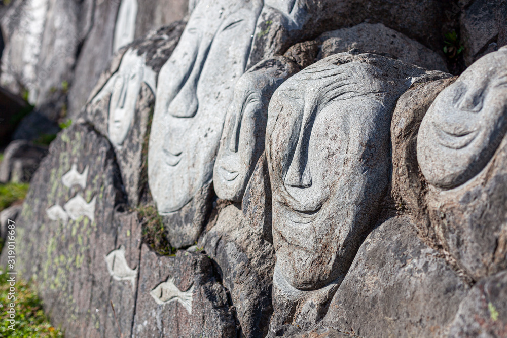 Staked Rocks Inuit Stone faces of Inuits sculpted on a stone in Qaqortoq. Greenland Stock ...