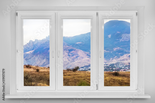 View from the window. Mountain forest landscape under evening sky