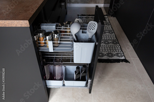 Kitchen storage solution. Pull out kitchen accessory for spice, bottles, kitchen spoons and even cutting boards. 