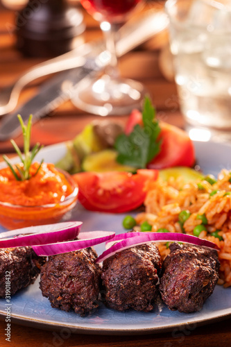 closeup of cevapcici with djuvec rice photo