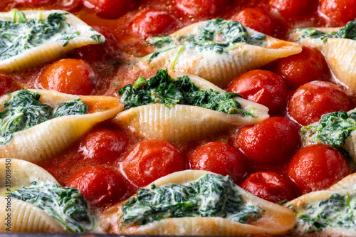 italian conchiglino pasta filled with spinach photo