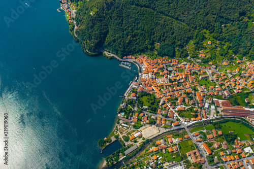 Aerial view of Como lake, Dongo, Italy. Coastline is washed by blue turquoise water
