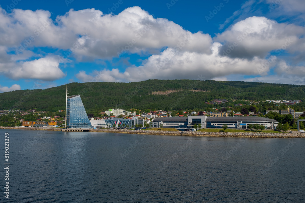 Naklejka premium Molde, Norway - july 2019. Modern architecture on the background of Scandinavian mountains and blue sky. Sunny day in Molde, Norway.
