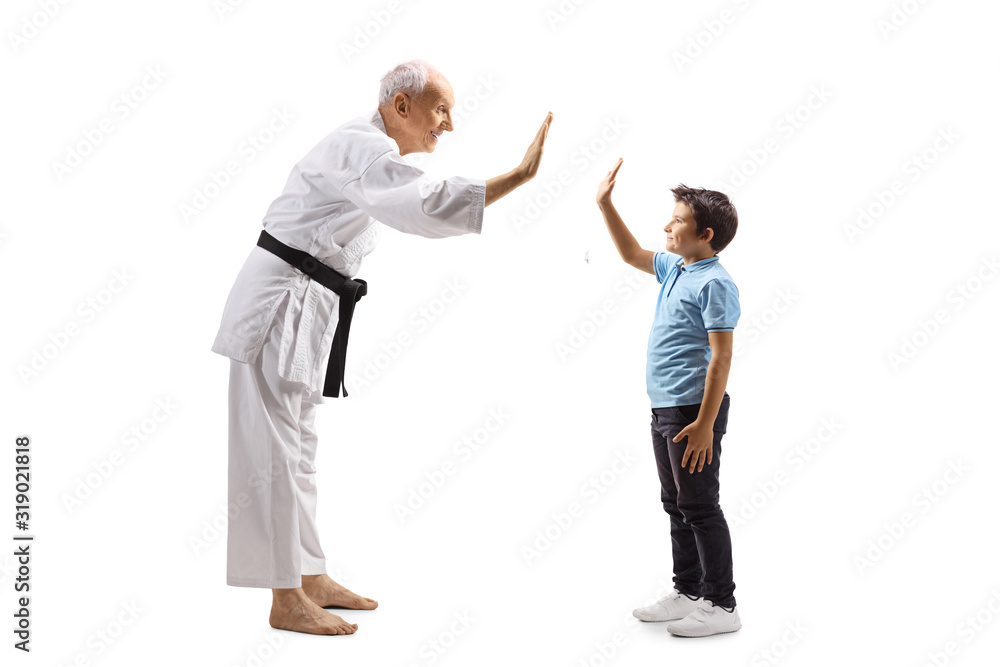 Boy and an elderly karate master gesturing high-five