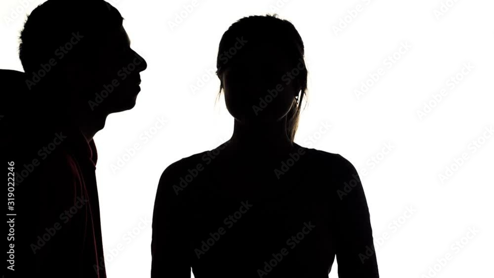 silhouette of young man and woman flirting, boy kissing girl in lips, concept love and romantic feelings silhouette of young man and woman flirting, boy kissing girl in lips, concept love and romantic feelings