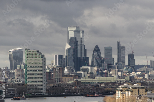 Panoramic view of the skyscrapers and office buildings found in the city of London appearing in the foreground the River Thames