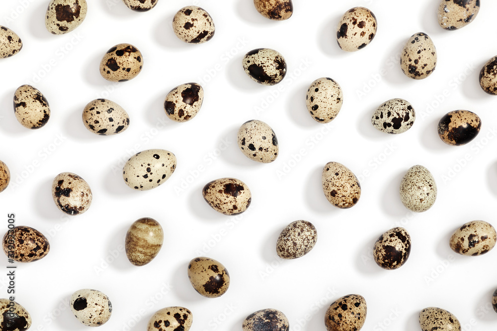 Quail eggs pattern. Big collection of quail eggs on white background. Easter concept. Flat lay, top view, copy space Quail eggs pattern. Big collection of quail eggs on white background. Easter concept. Flat lay, top view, copy space
