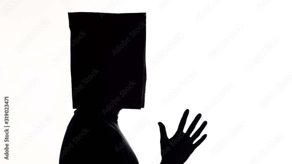 Funny man with paper bags on his head having fun on white isolated background, silhouette figure move head and dancing, concept mood Funny man with paper bags on his head having fun on white isolated background, silhouette figure move head and dancing, concept mood