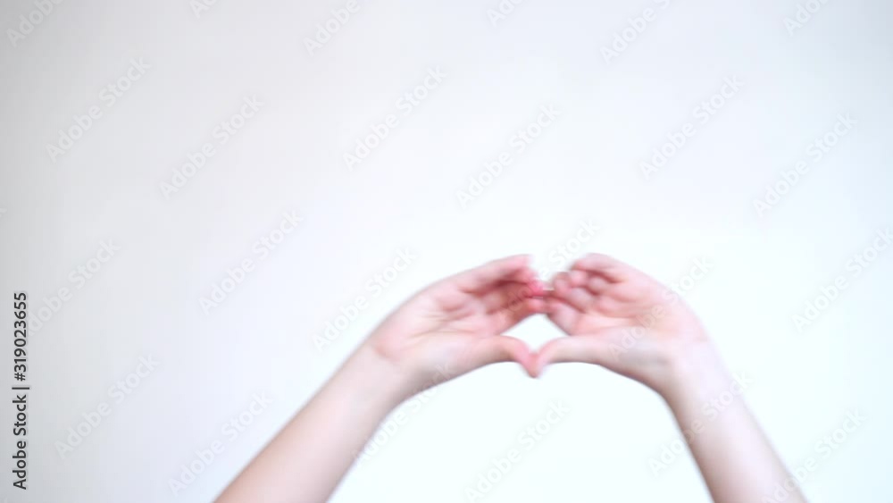 Female blogger hand made heart shape, dancing to music rhythm isolated on yellow white color background. Like blogging blog social network tenderness concept. Female blogger hand made heart shape, dancing to music rhythm isolated on yellow white color background. Like blogging blog social network tenderness concept.