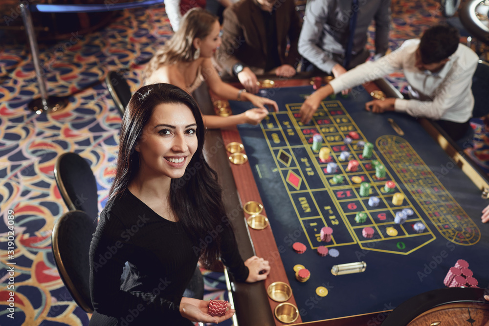 Happy smiling girl smiling at the roulette in a casino Stock Photo ...