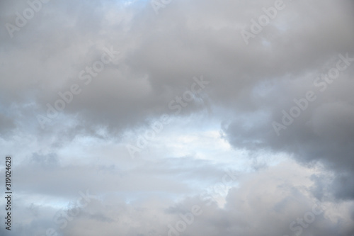 Late afternoon blue sky with white and gray clouds as a nature background