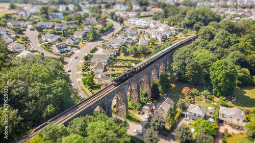 Passenger steam train passes over the Hookhills Viaduct built by Brunel in 1860