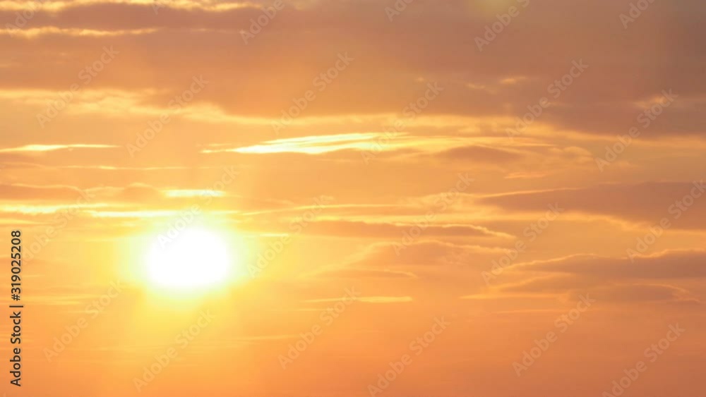 beautiful sunset on the background of sea, sun going beyond the horizon illuminating water and clouds in the sky beautiful sunset on the background of sea, sun going beyond the horizon illuminating water and clouds in the sky