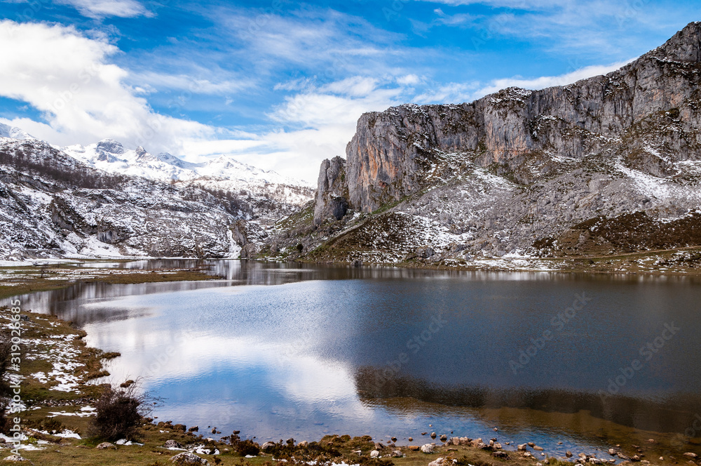Fototapeta premium Reflections of snowy mountains over Covadonga Lakes
