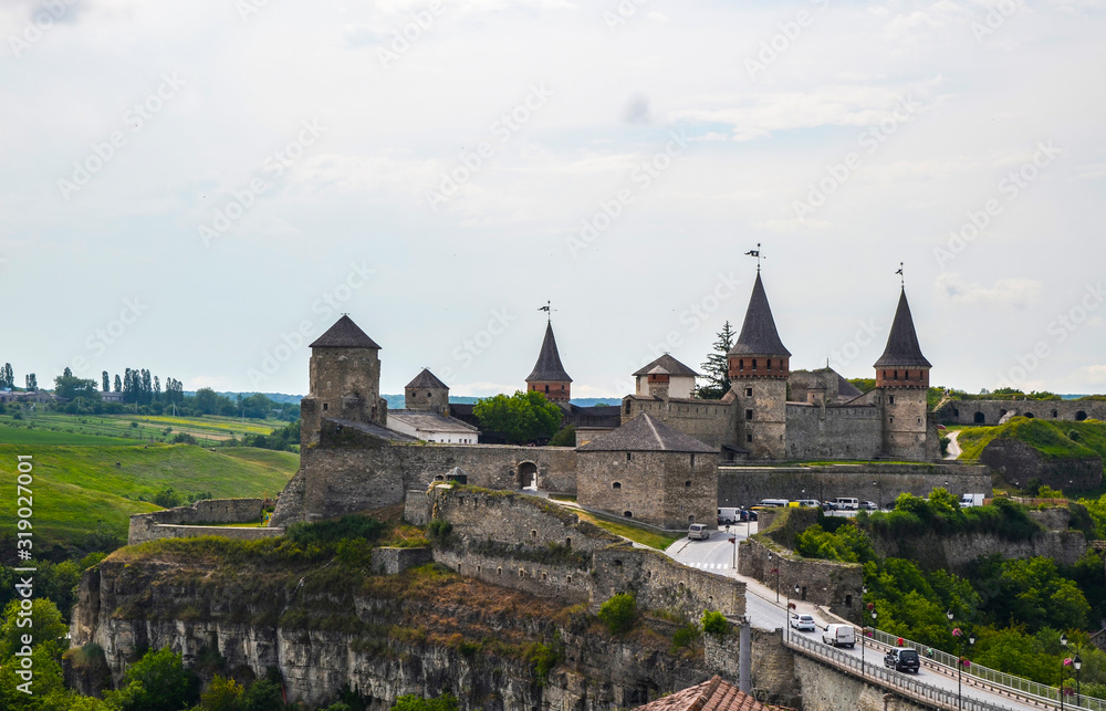 Summer view on the old Kamianets-Podilskyi castle located in Khmelnytsky region of Ukraine. Kamianets-Podilskyi castle is very popular among tourists.