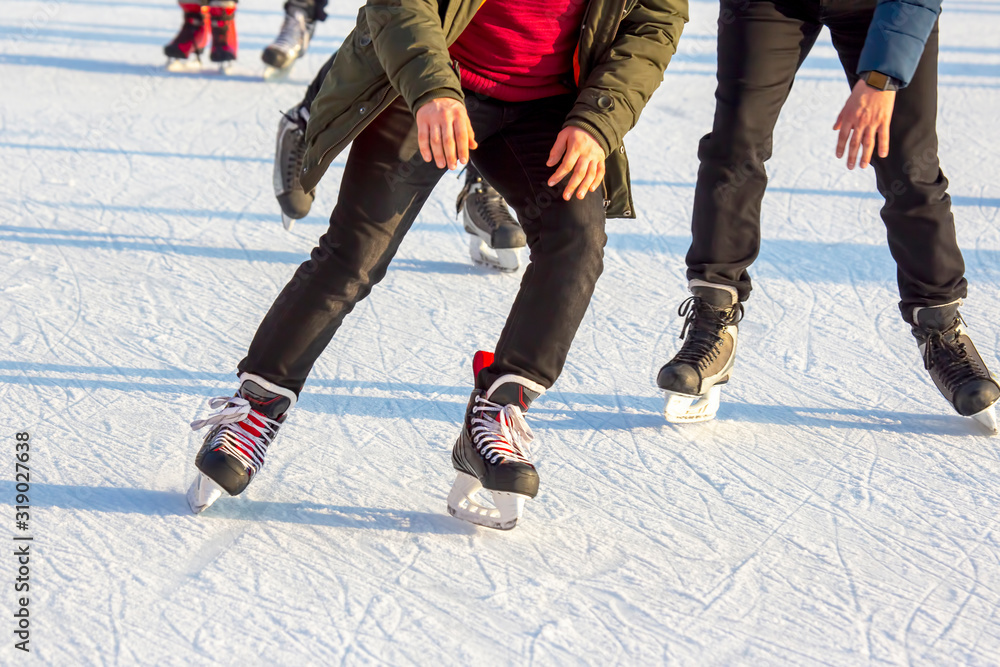 people ice skating on an ice rink. hobbies and leisure. winter sports people ice skating on an ice rink. hobbies and leisure. winter sports