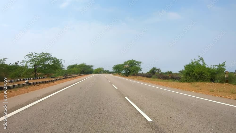 Driving a Car on a Road in Rajasthan India Driving a Car on a Road in Rajasthan India